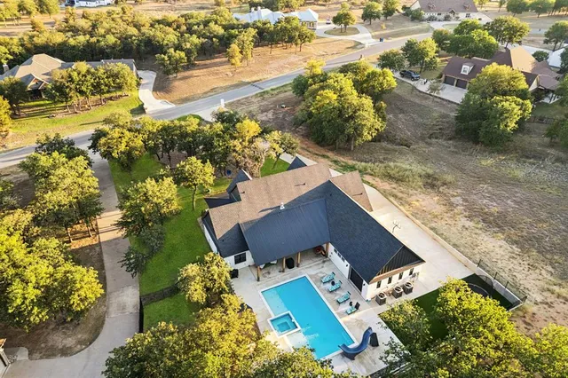 an aerial view of a house with a yard