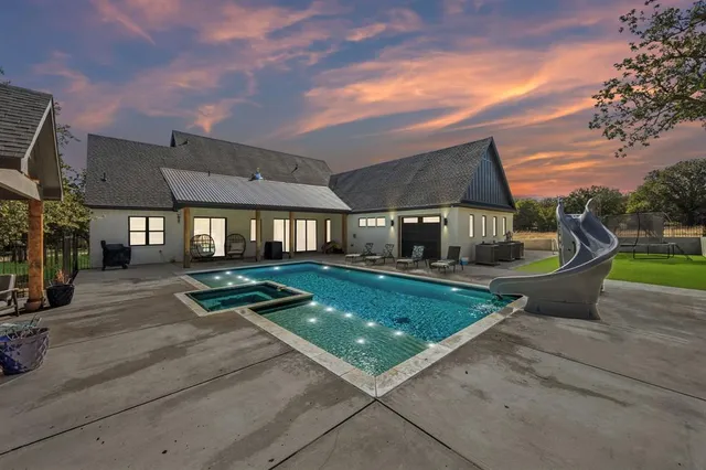 a view of a house with backyard porch and sitting area