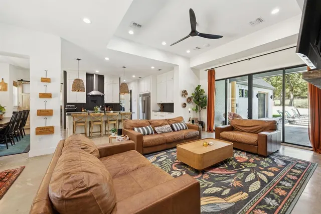 a living room with furniture ceiling fan and a rug