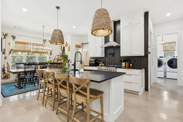 a kitchen with stainless steel appliances granite countertop a sink a stove and a wooden floors