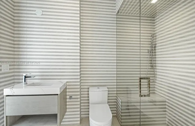 a bathroom with a shower and a toilet