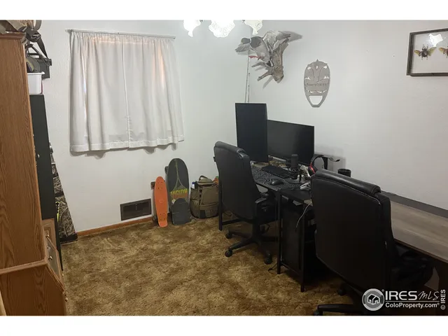 a kitchen with a refrigerator and a desk