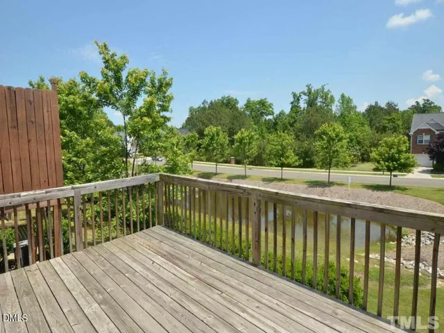 a balcony with wooden floor and fence