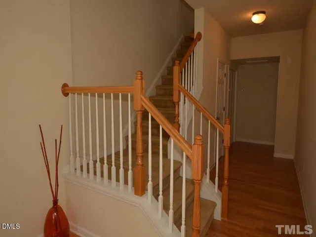 a view of staircase with railing and white walls