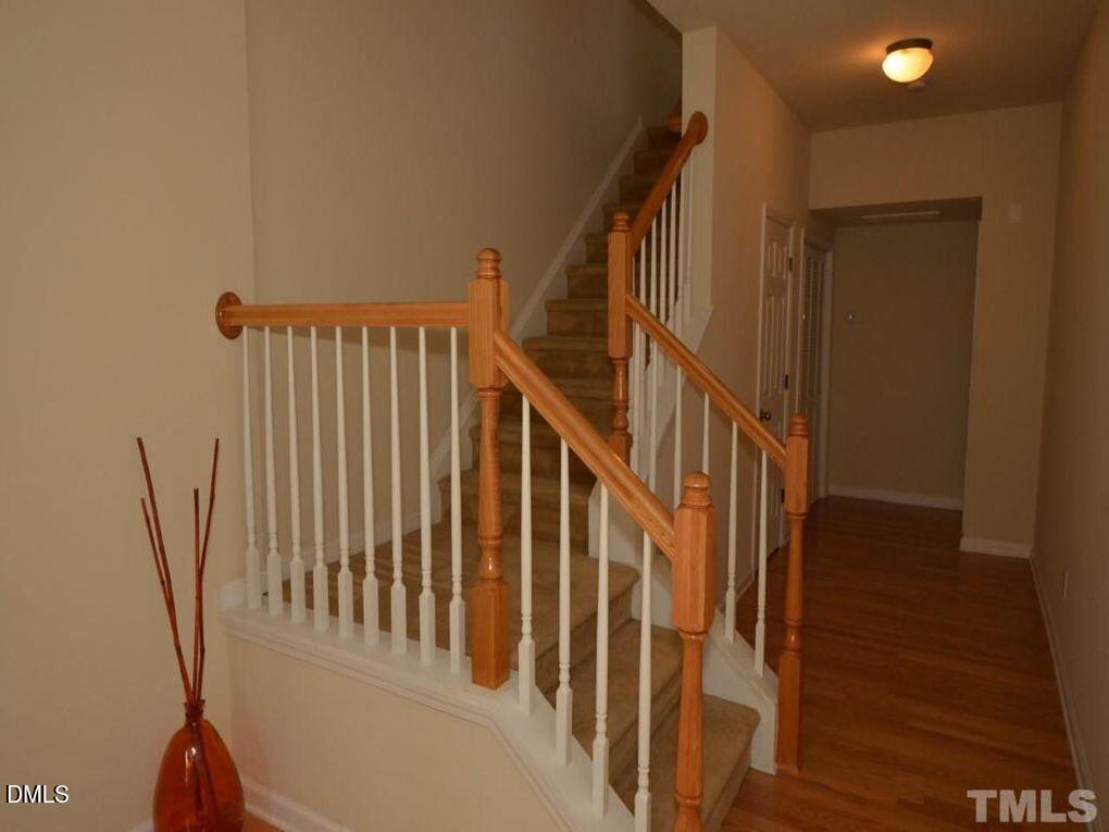 114 Gallent Hedge Trail Apex, NC 27539 - Photo 2 of 18 a view of staircase with railing and white walls
