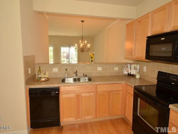 a kitchen with a sink stove and microwave