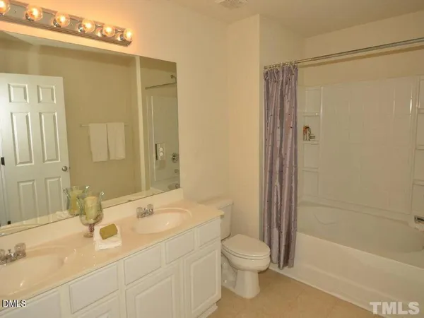 a bathroom with a sink mirror toilet and bathtub