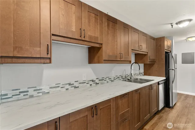 a kitchen with stainless steel appliances granite countertop a sink stove and cabinets