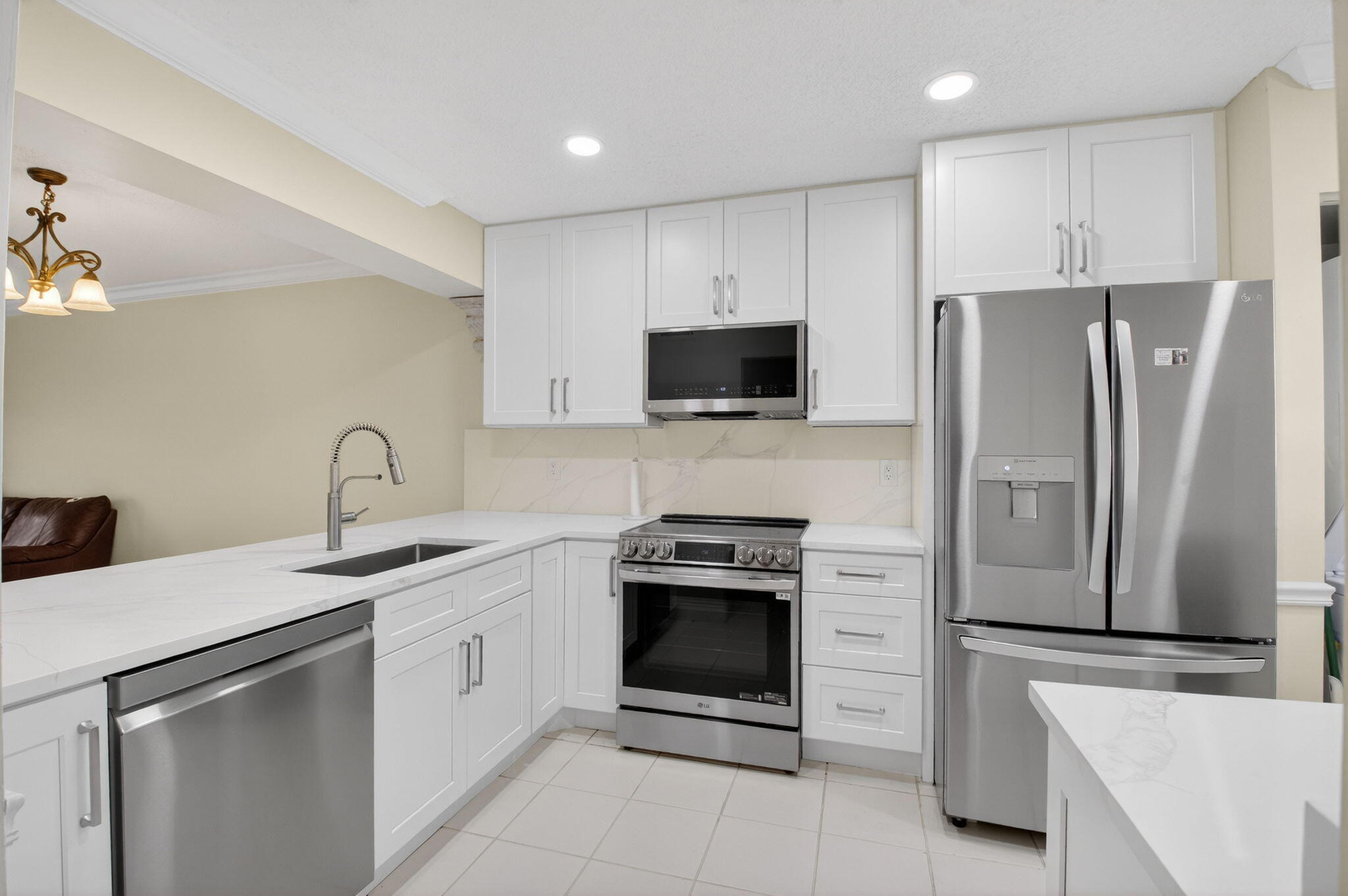 159 Northwest 70th Street, Unit 403 Boca Raton, FL 33487 - Photo 2 of 30 a kitchen with stainless steel appliances a stove sink and refrigerator