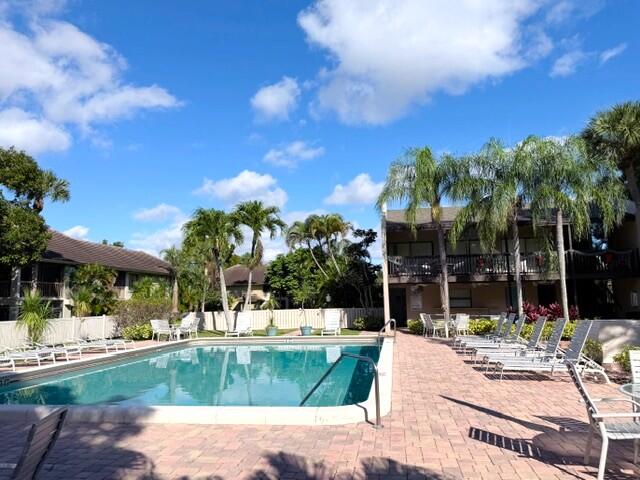 159 Northwest 70th Street, Unit 403 Boca Raton, FL 33487 - Photo 23 of 30 a view of a swimming pool with a patio