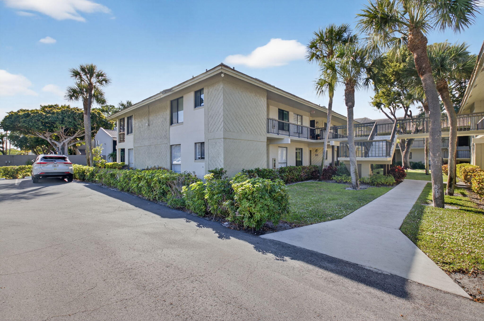 159 Northwest 70th Street, Unit 403 Boca Raton, FL 33487 - Photo 25 of 30 a front view of a house with garden