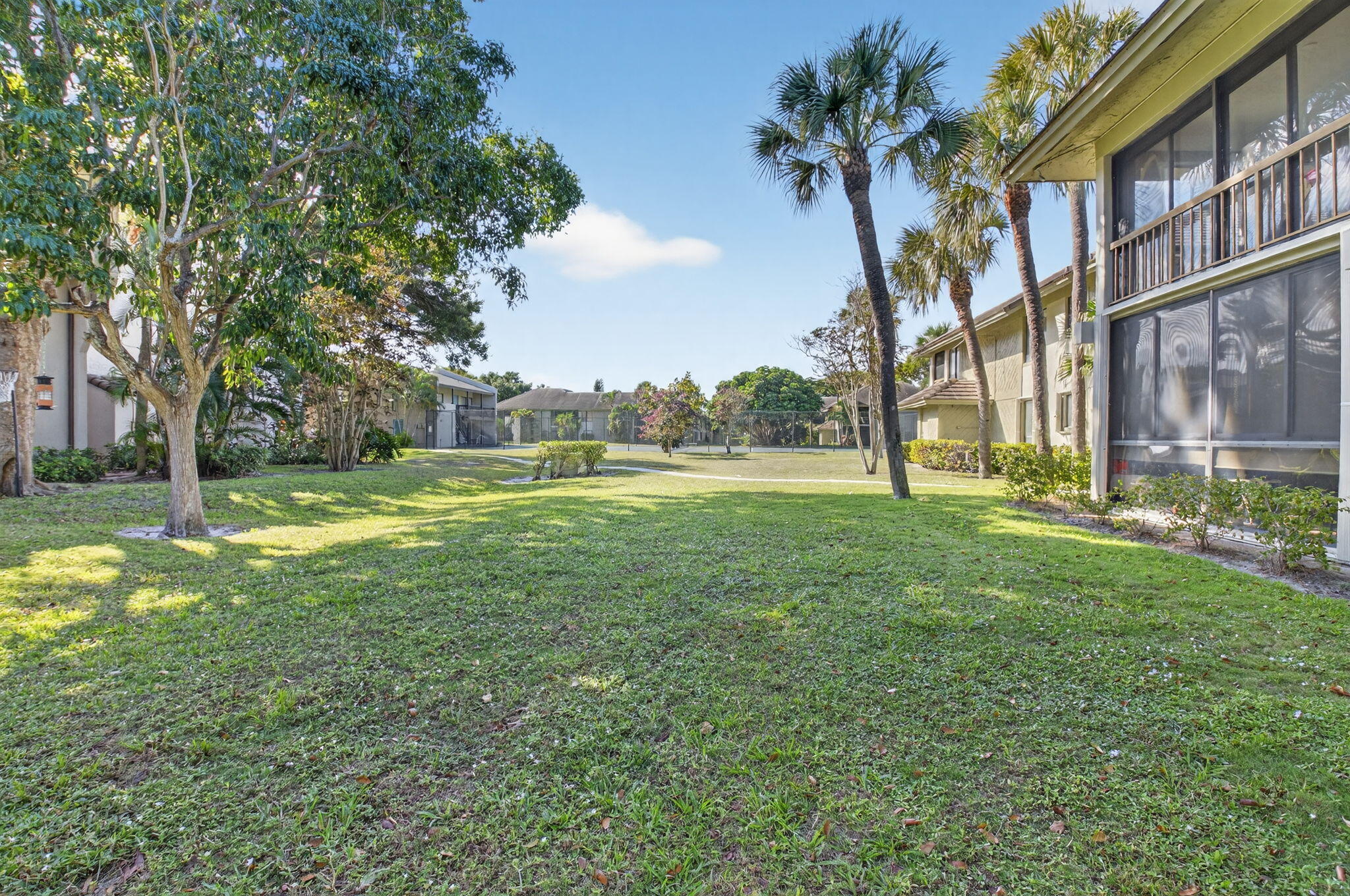 159 Northwest 70th Street, Unit 403 Boca Raton, FL 33487 - Photo 27 of 30 a view of a big yard with palm trees