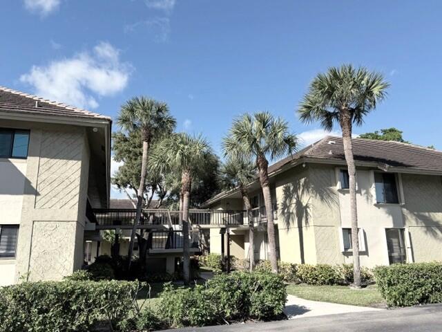 159 Northwest 70th Street, Unit 403 Boca Raton, FL 33487 - Photo 28 of 30 a front view of a house with a yard