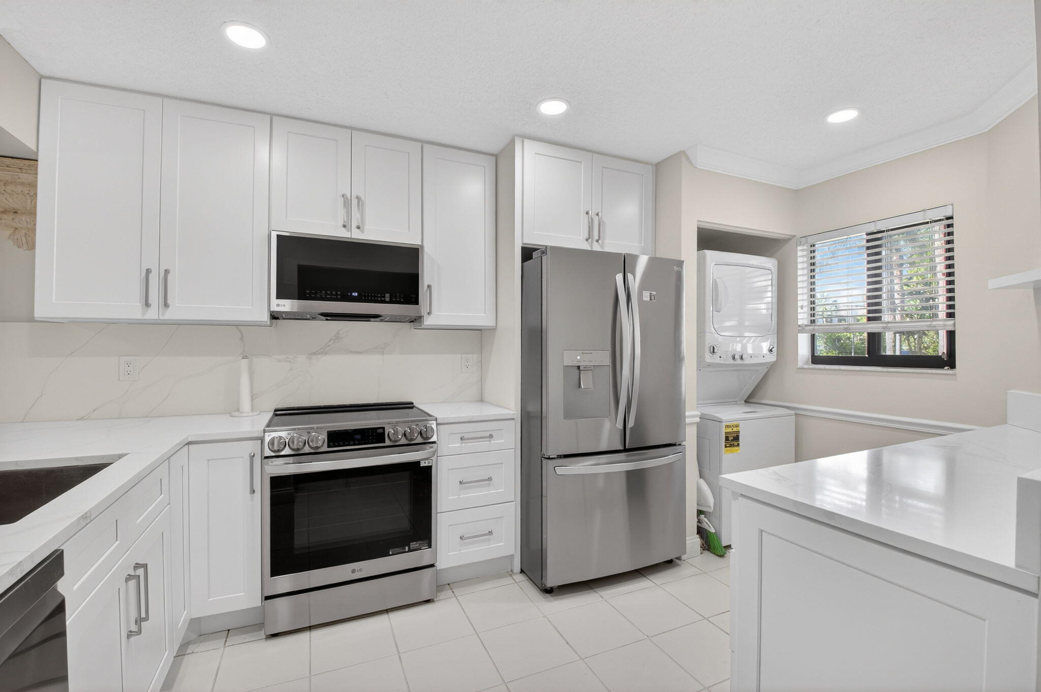 159 Northwest 70th Street, Unit 403 Boca Raton, FL 33487 - Photo 3 of 30 a kitchen with a refrigerator stove and microwave