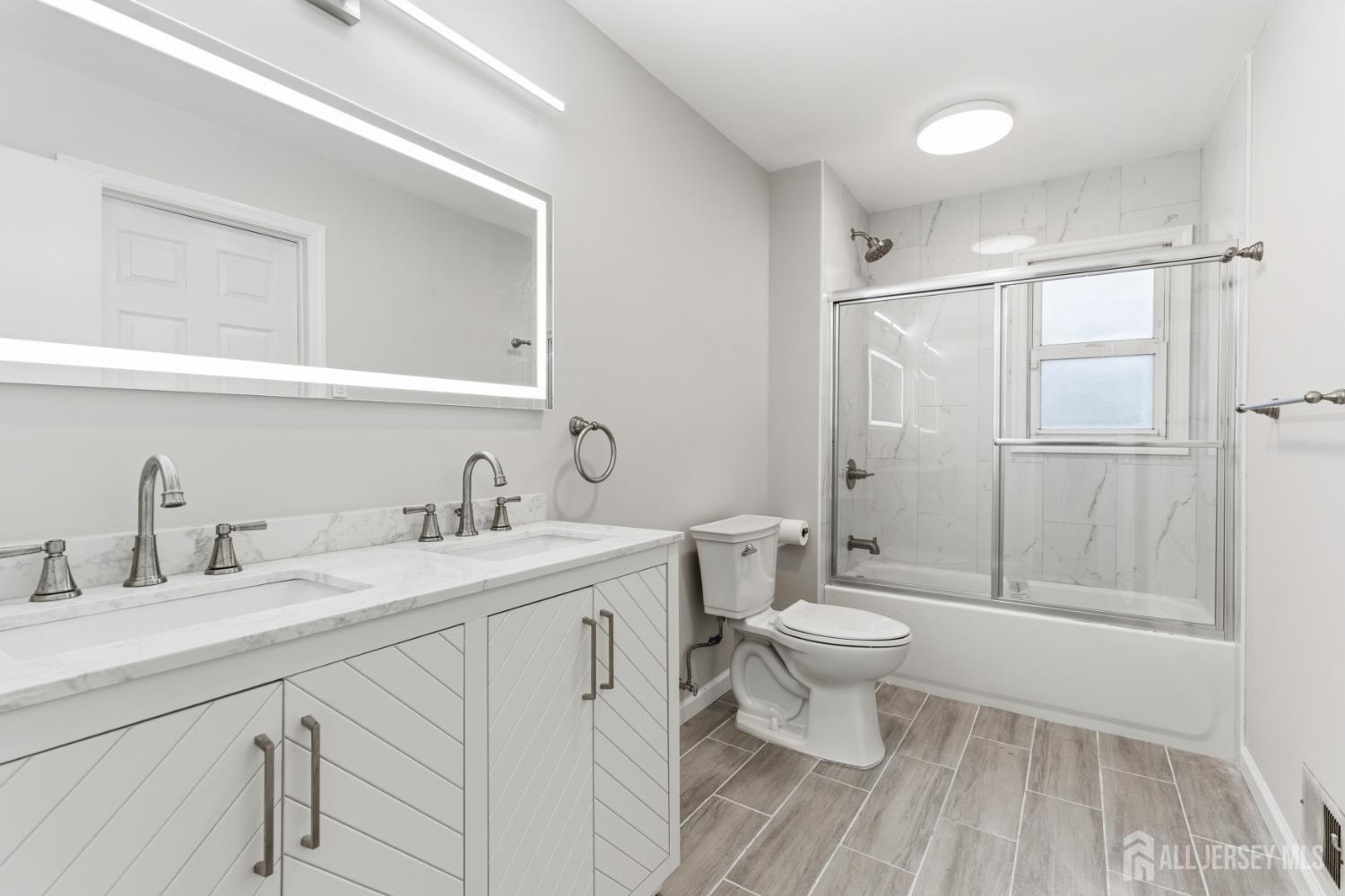 5 McKinley Street Edison, NJ 08820 - Photo 26 of 38 a bathroom with a sink toilet and shower