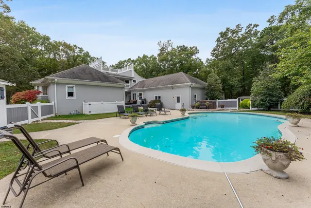 a living room with kitchen island furniture and a chandelier