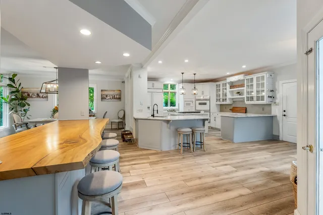 a view of a workspace with furniture and wooden floor