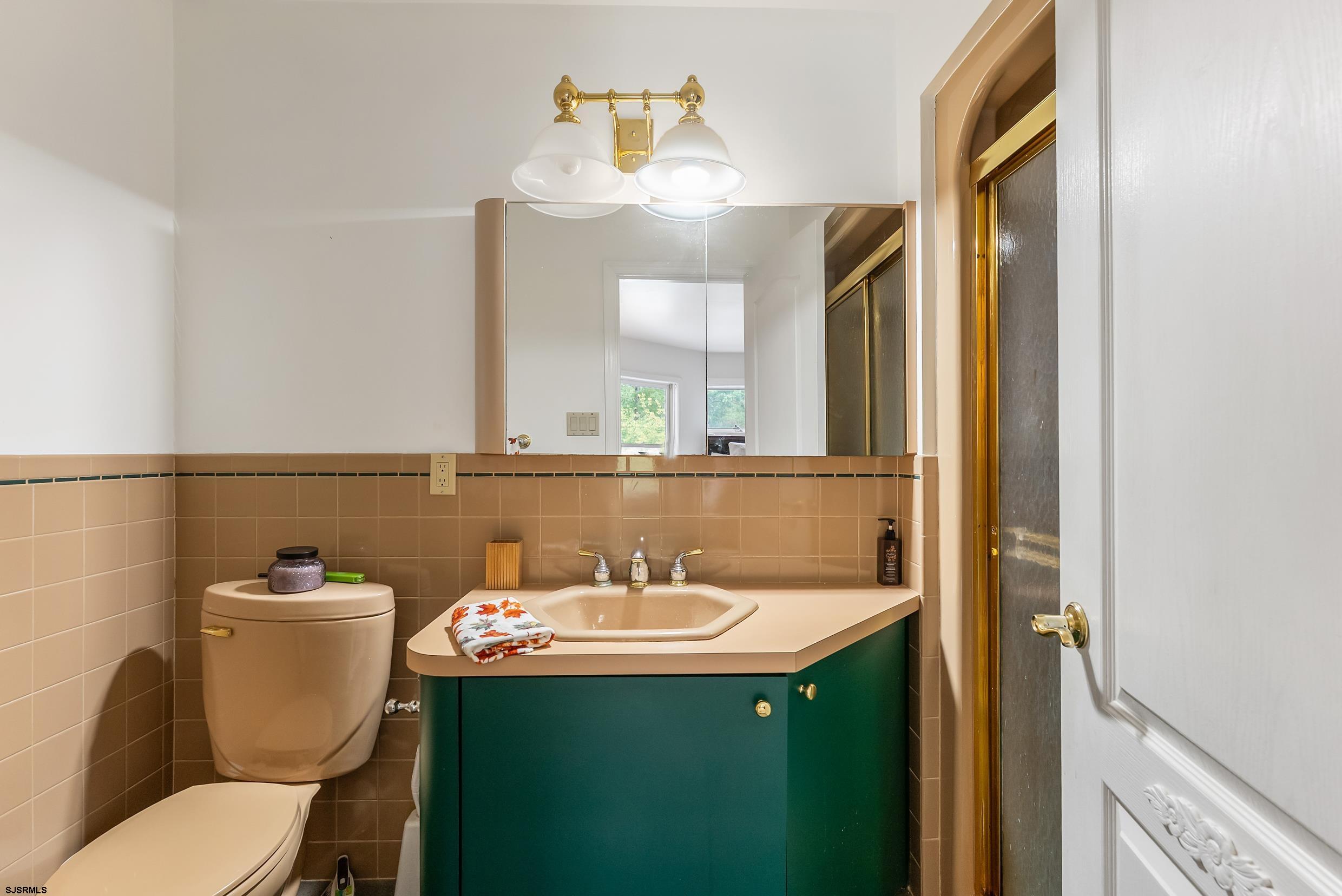 535 West Cologne Port Road Port Republic, NJ 08215 - Photo 62 of 99 a bathroom with a sink and a mirror