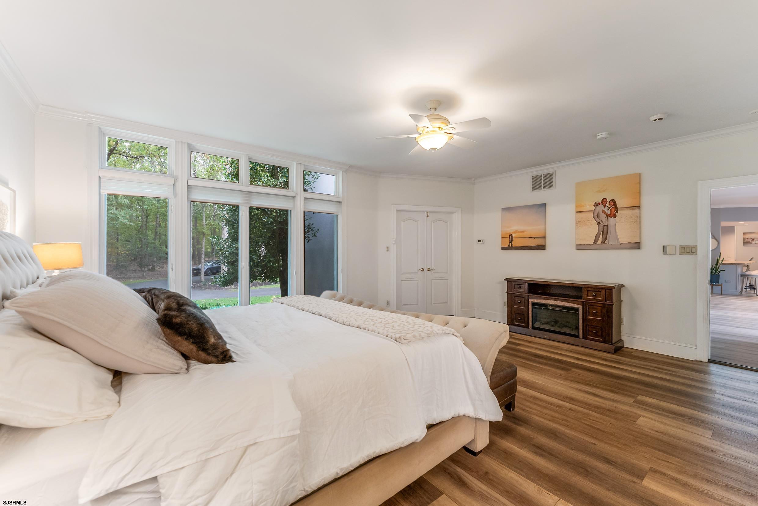 535 West Cologne Port Road Port Republic, NJ 08215 - Photo 67 of 99 a bedroom with a bed and a fireplace