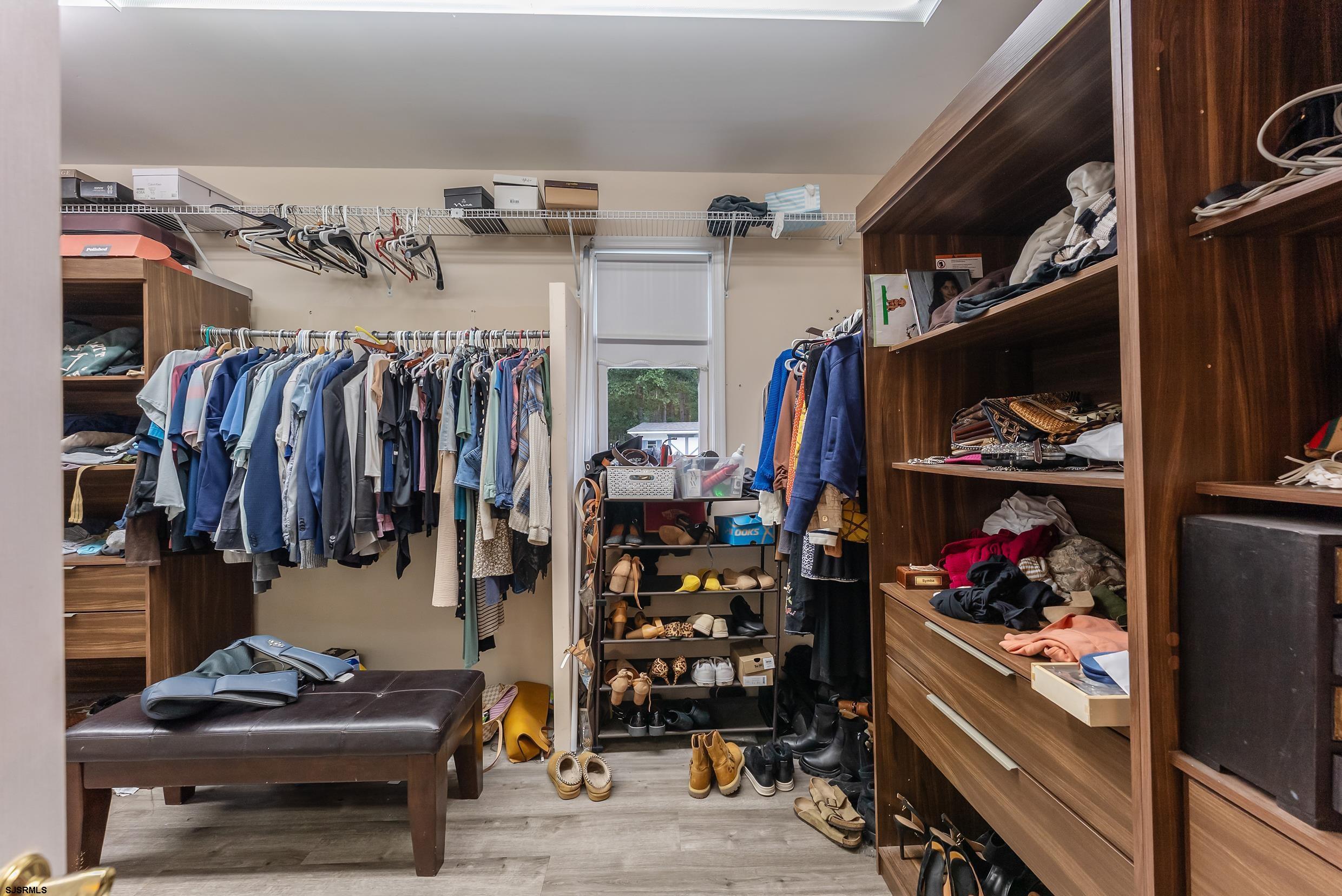 535 West Cologne Port Road Port Republic, NJ 08215 - Photo 69 of 99 a view of walk in closet with clothes and shoes