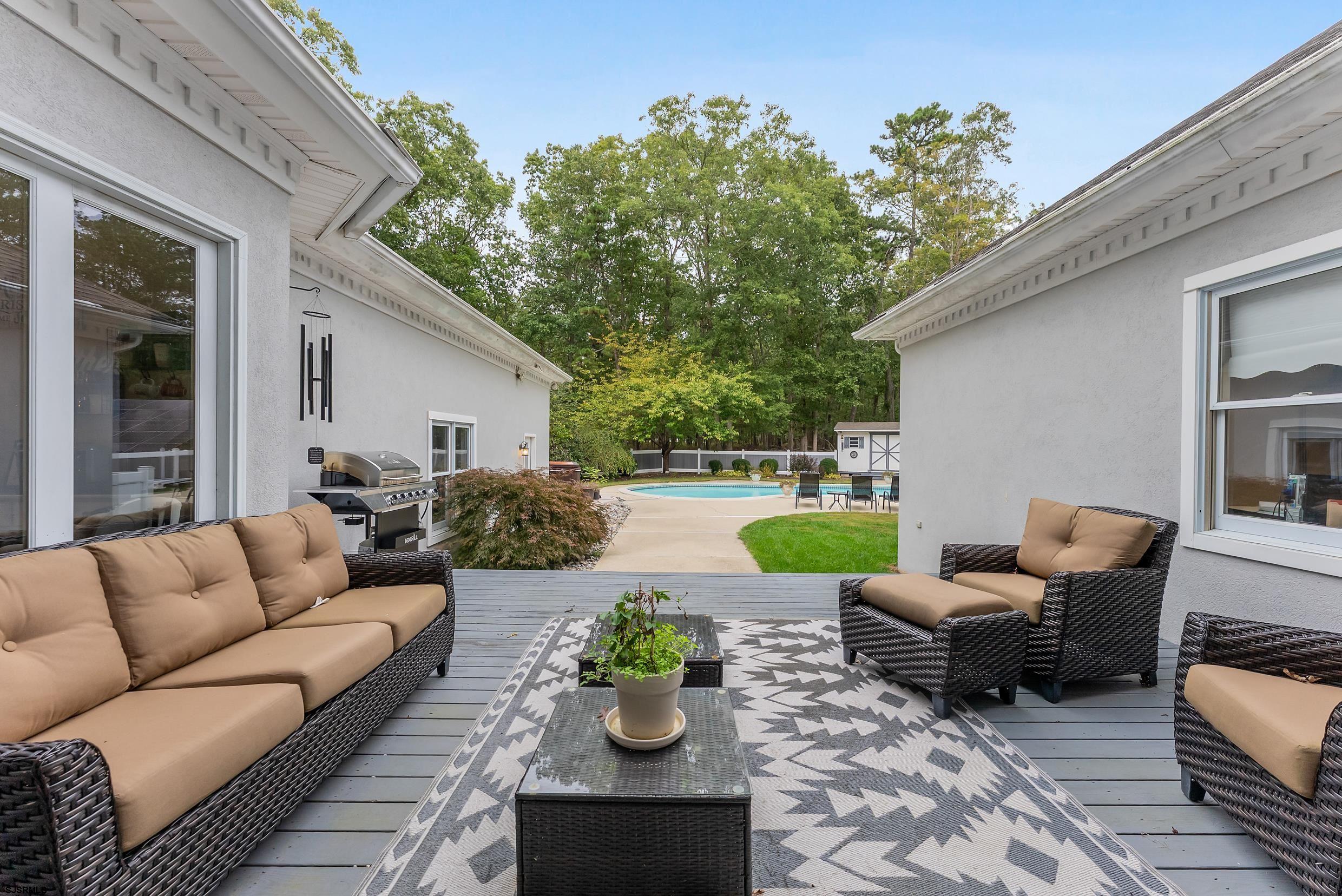 535 West Cologne Port Road Port Republic, NJ 08215 - Photo 7 of 99 a view of a patio with couches potted plants and a large window