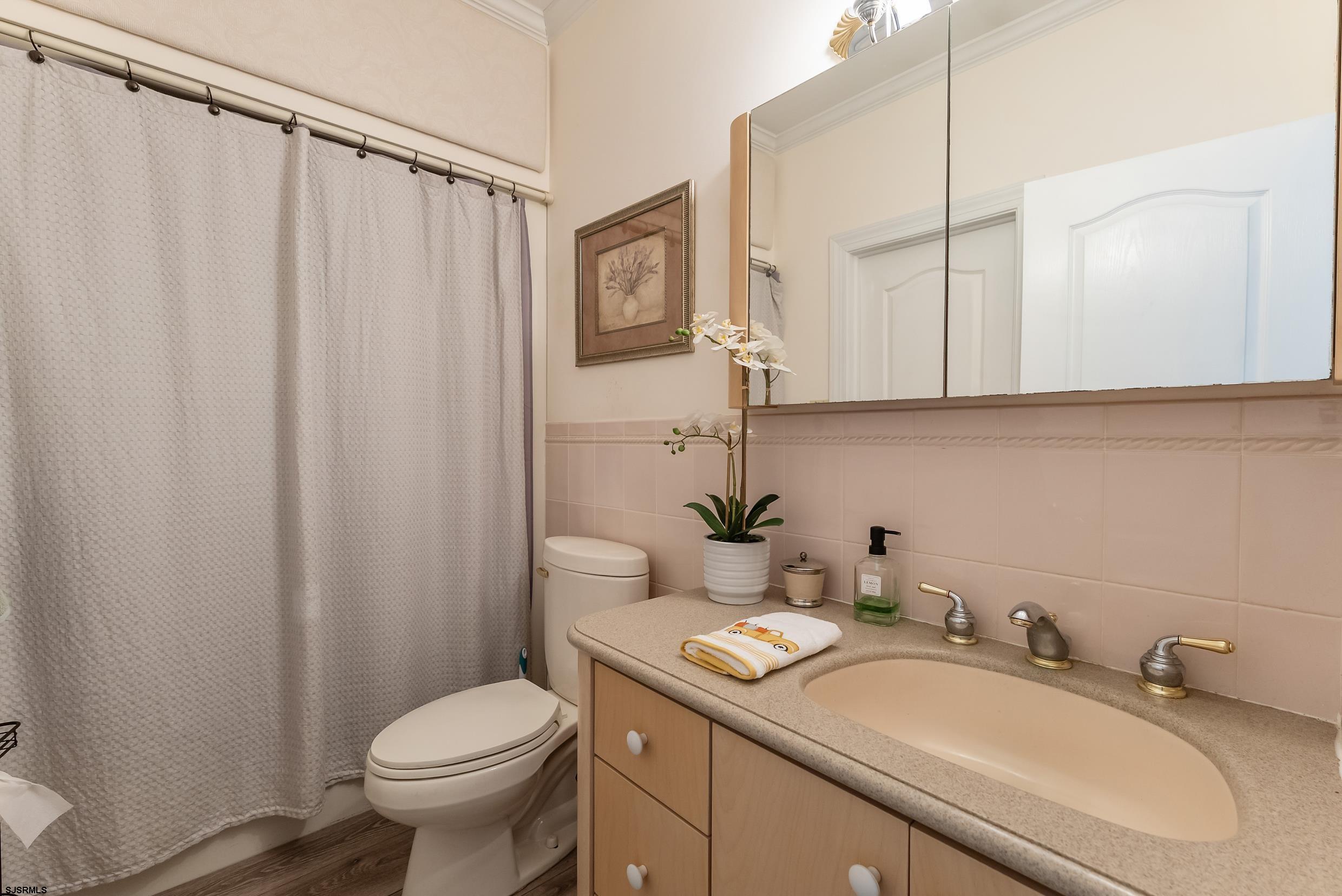 535 West Cologne Port Road Port Republic, NJ 08215 - Photo 75 of 99 a bathroom with a granite countertop sink and a mirror