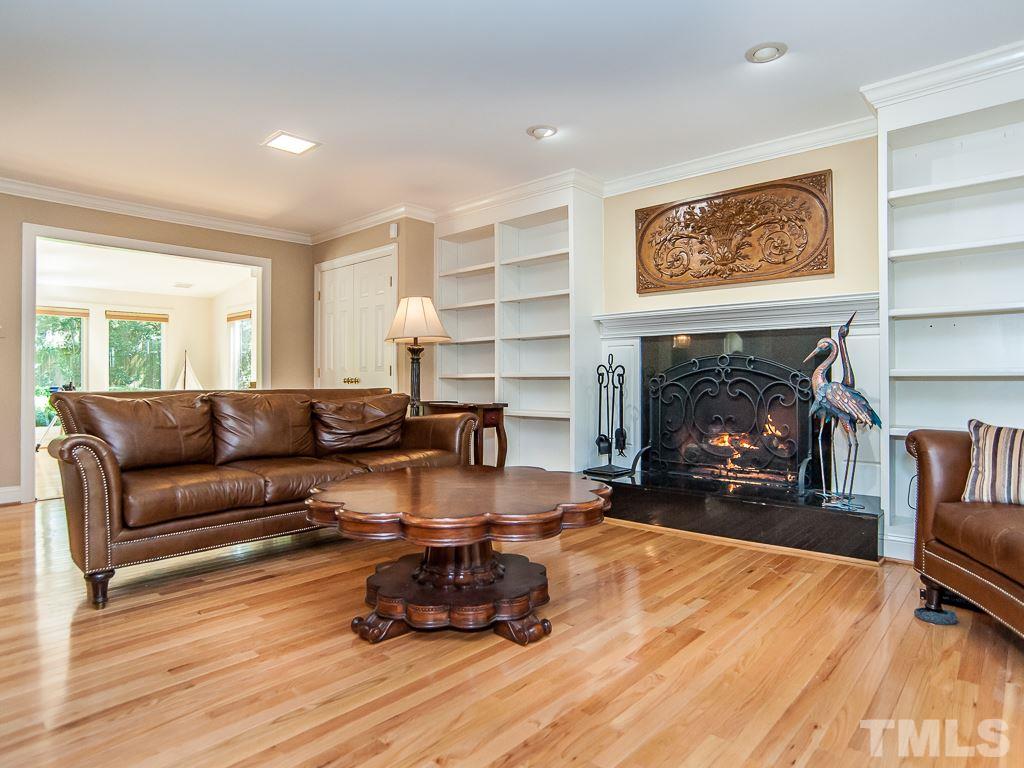 6920 Slade Hill Road Raleigh, NC 27615 - Photo 5 of 30 a living room with furniture and a fireplace