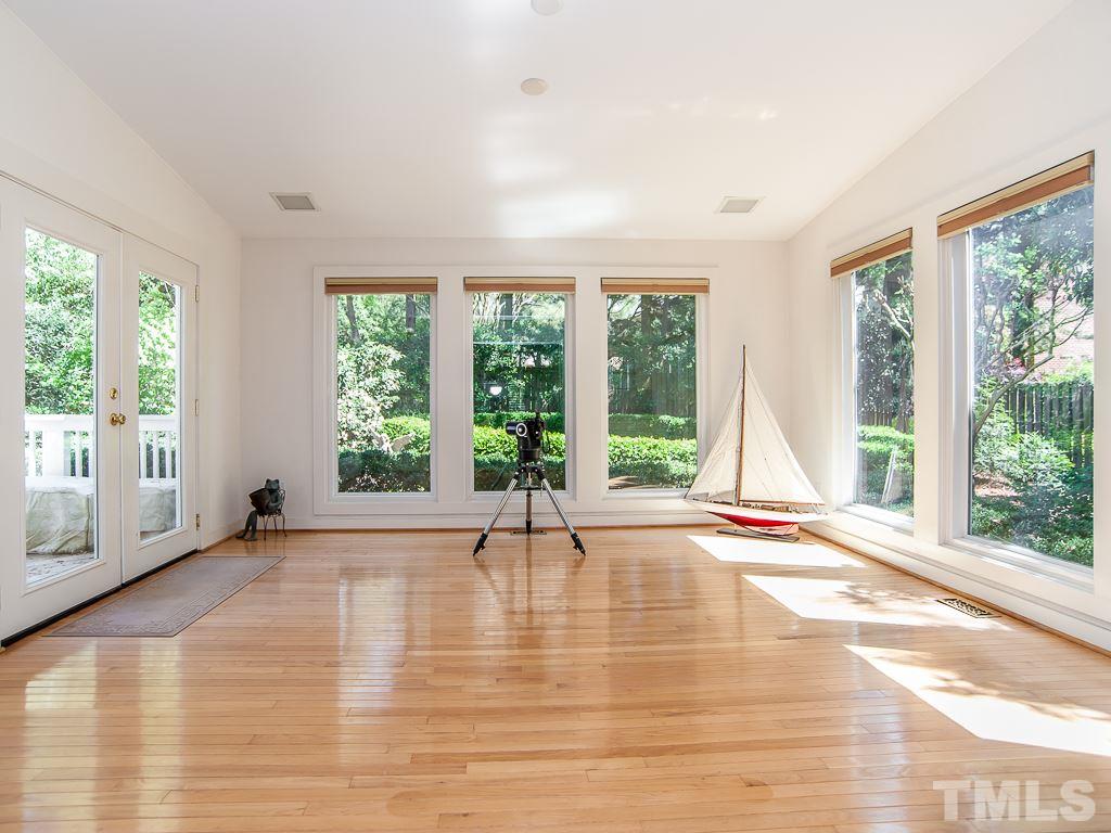 6920 Slade Hill Road Raleigh, NC 27615 - Photo 7 of 30 a view of an empty room with wooden floor and a window