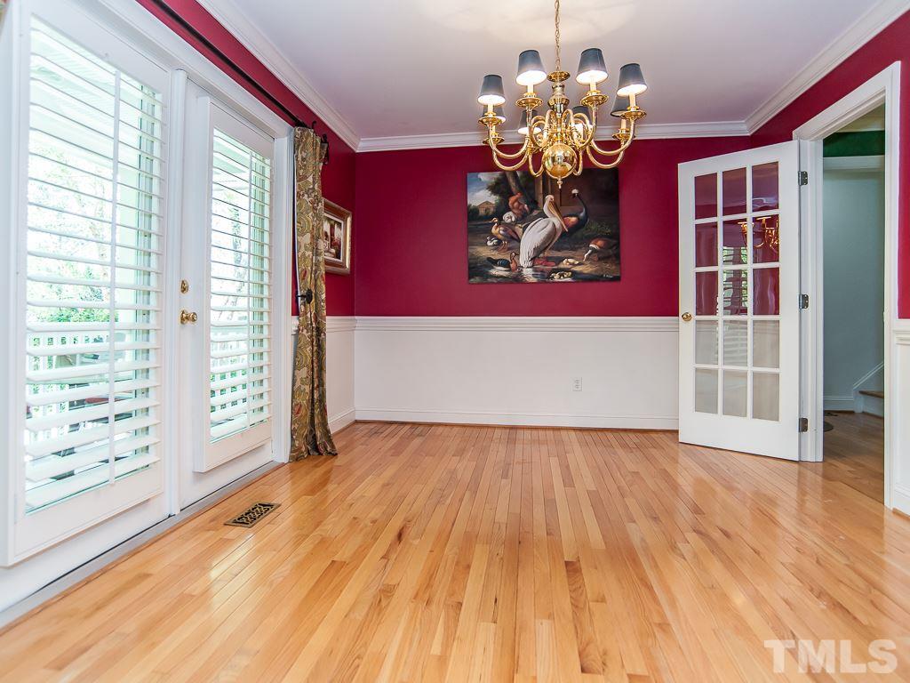 6920 Slade Hill Road Raleigh, NC 27615 - Photo 9 of 30 a view of an empty room with window and wooden floor