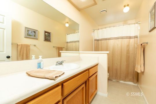 1217 Flora Way Ridgecrest, CA 93555 - Photo 30 of 39 a bathroom with a sink and a mirror