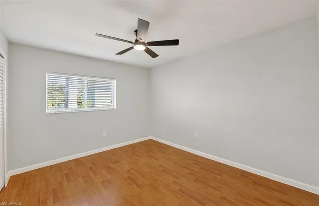 a view of a big room with wooden floor closet and windows