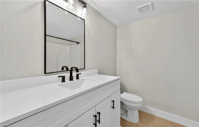 a bathroom with a sink a toilet and mirror