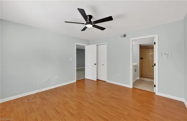 a view of empty room with wooden floor