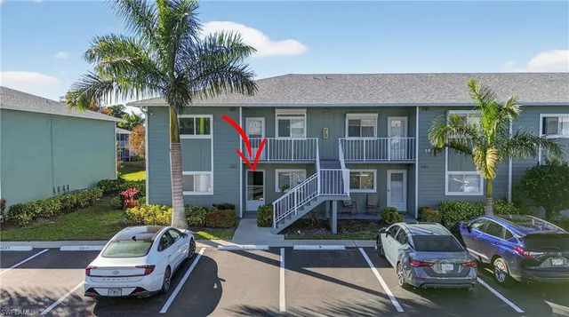 a front view of house with car parked