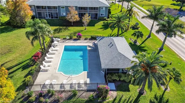 an aerial view of a house with a garden and swimming pool