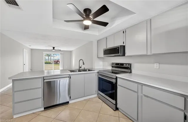 a kitchen with cabinets appliances and a sink