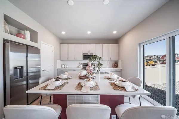 a kitchen with a sink cabinets and wooden floor