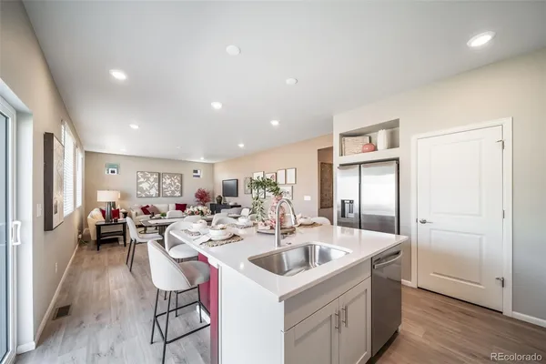 a kitchen with a dining table cabinets appliances and cabinets