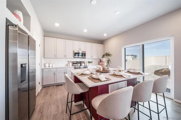 a kitchen with sink stove and cabinets