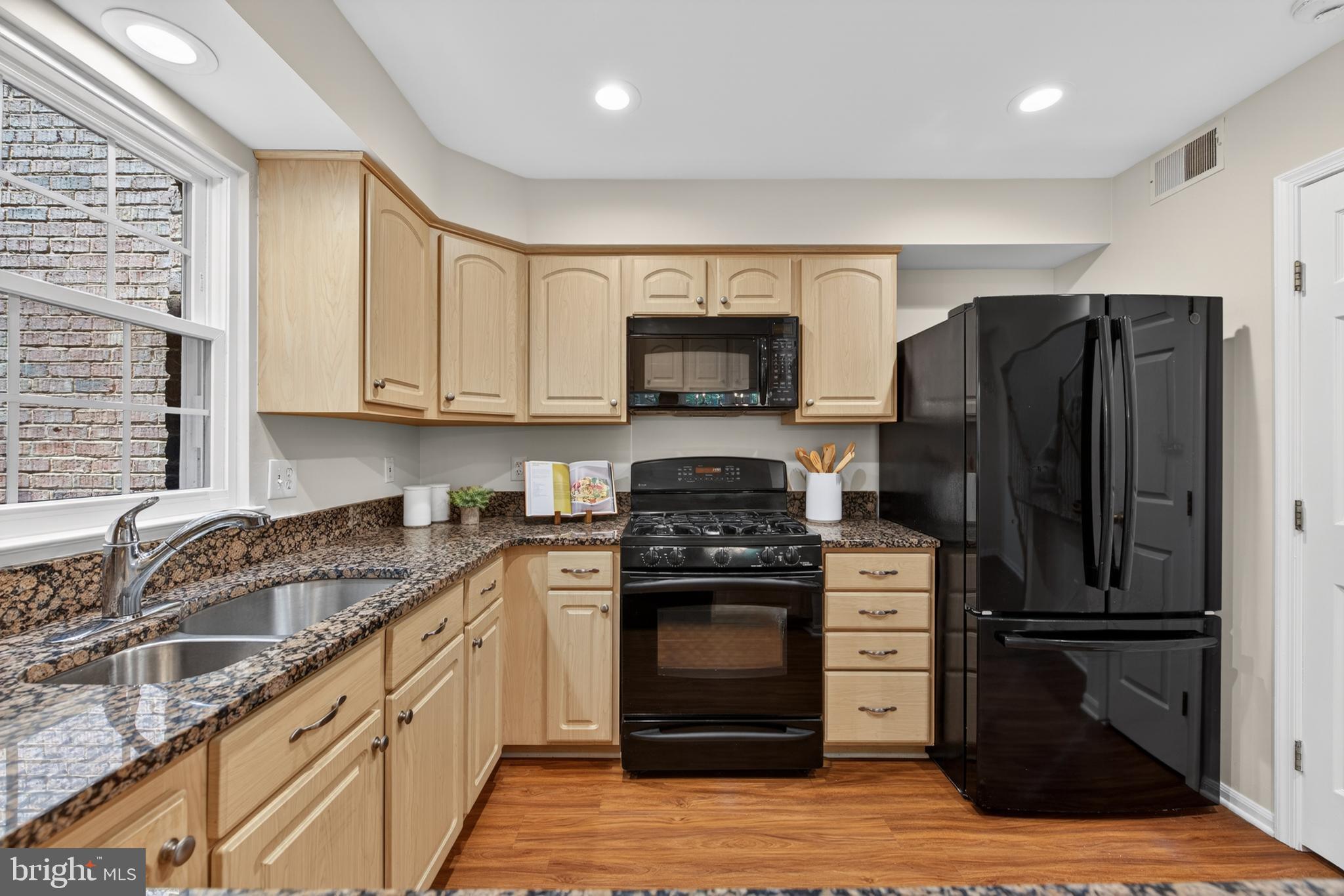 1409 Park Garden Lane Reston, VA 20194 - Photo 18 of 41 a kitchen with granite countertop a refrigerator stove and sink