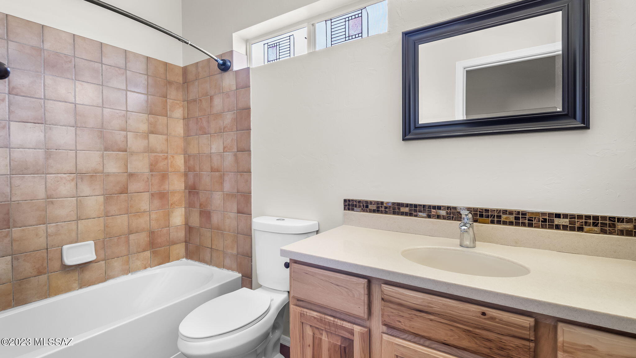 300 Circulo Bellagio Rio Rico, AZ 85648 - Photo 17 of 27 a bathroom with a sink a toilet and shower curtain