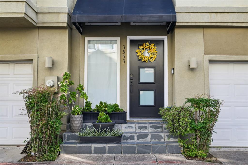 3553 Wheeler Street Dallas, TX 75209 - Photo 3 of 35 Welcoming front entry with covered awning and landscaped planters at gated West Highland Park townhome