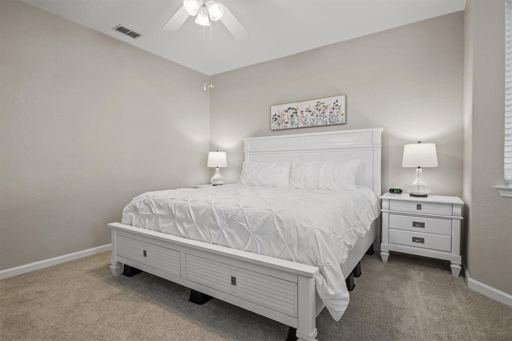 301 Terrace Ridge Circle, Unit 301 Davenport, FL 33896 - Photo 12 of 35 a bedroom with a bed and a chandelier