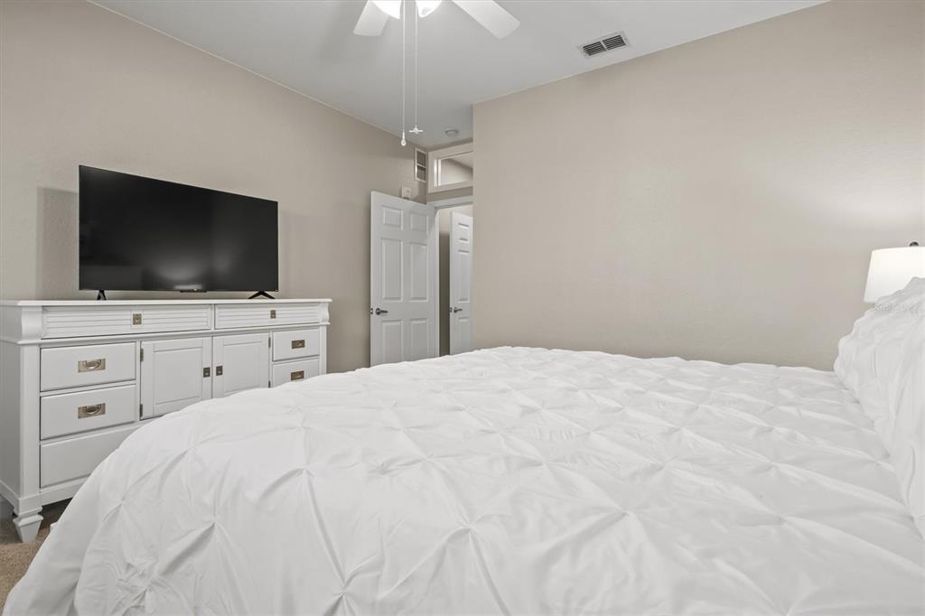 301 Terrace Ridge Circle, Unit 301 Davenport, FL 33896 - Photo 13 of 35 a bedroom with a bed and a flat screen tv