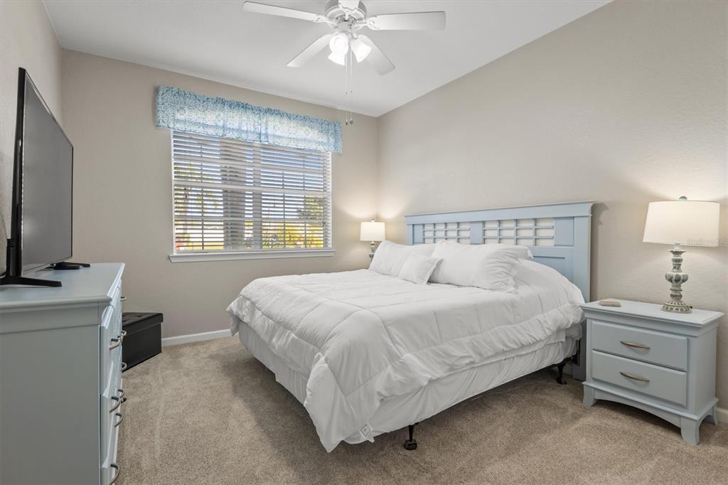 301 Terrace Ridge Circle, Unit 301 Davenport, FL 33896 - Photo 15 of 35 a bedroom with a bed and a flat screen tv