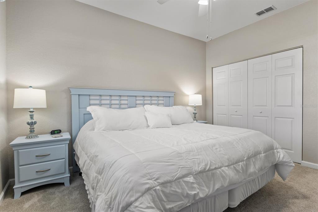 301 Terrace Ridge Circle, Unit 301 Davenport, FL 33896 - Photo 16 of 35 a bedroom with a bed and a night stand