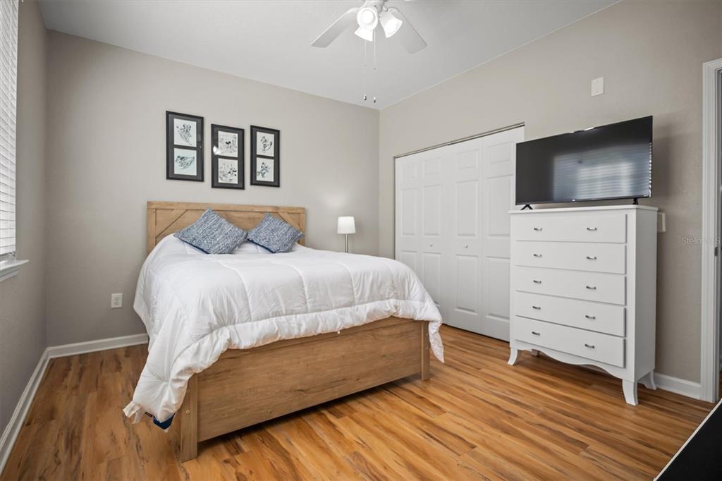 301 Terrace Ridge Circle, Unit 301 Davenport, FL 33896 - Photo 19 of 35 a bedroom with a bed and a television