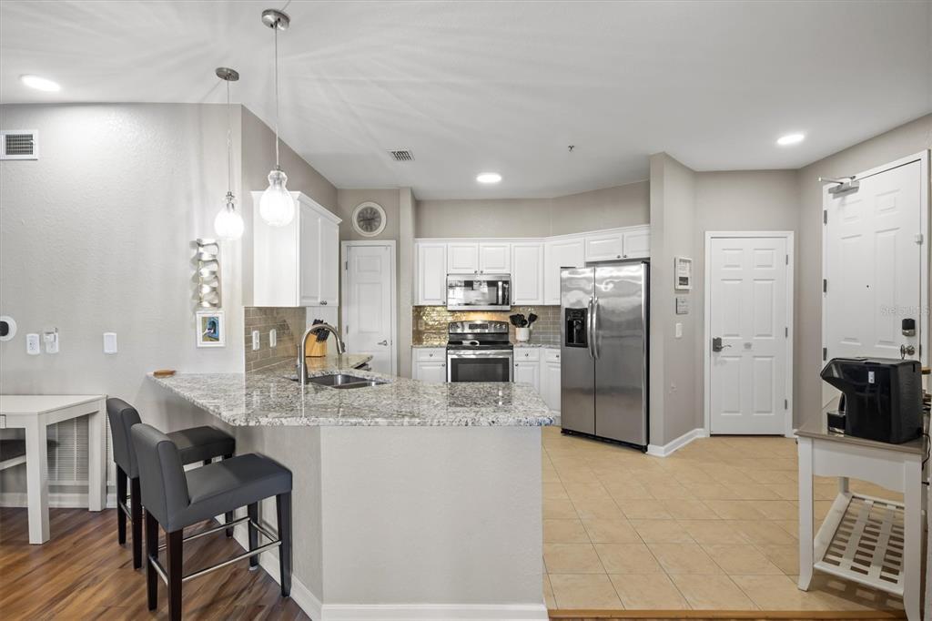 301 Terrace Ridge Circle, Unit 301 Davenport, FL 33896 - Photo 4 of 35 a kitchen with refrigerator and cabinets