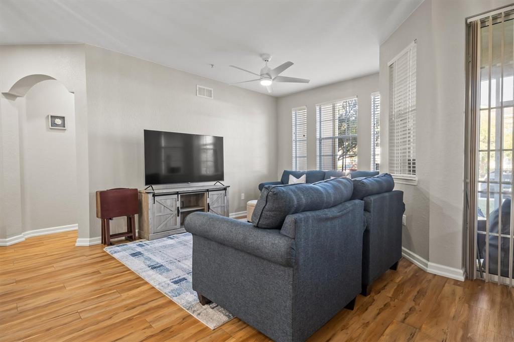 301 Terrace Ridge Circle, Unit 301 Davenport, FL 33896 - Photo 8 of 35 a living room with furniture and a flat screen tv