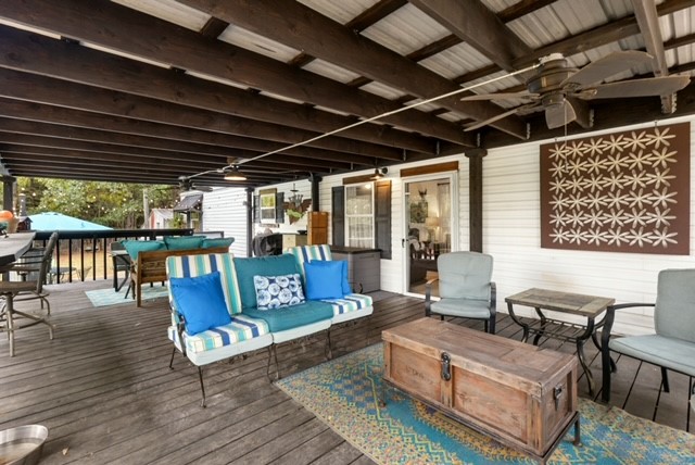 215 South Bk 802 Road Stigler, OK 74462 - Photo 9 of 20 Expansive covered deck with exposed wood beams and a metal ceiling
